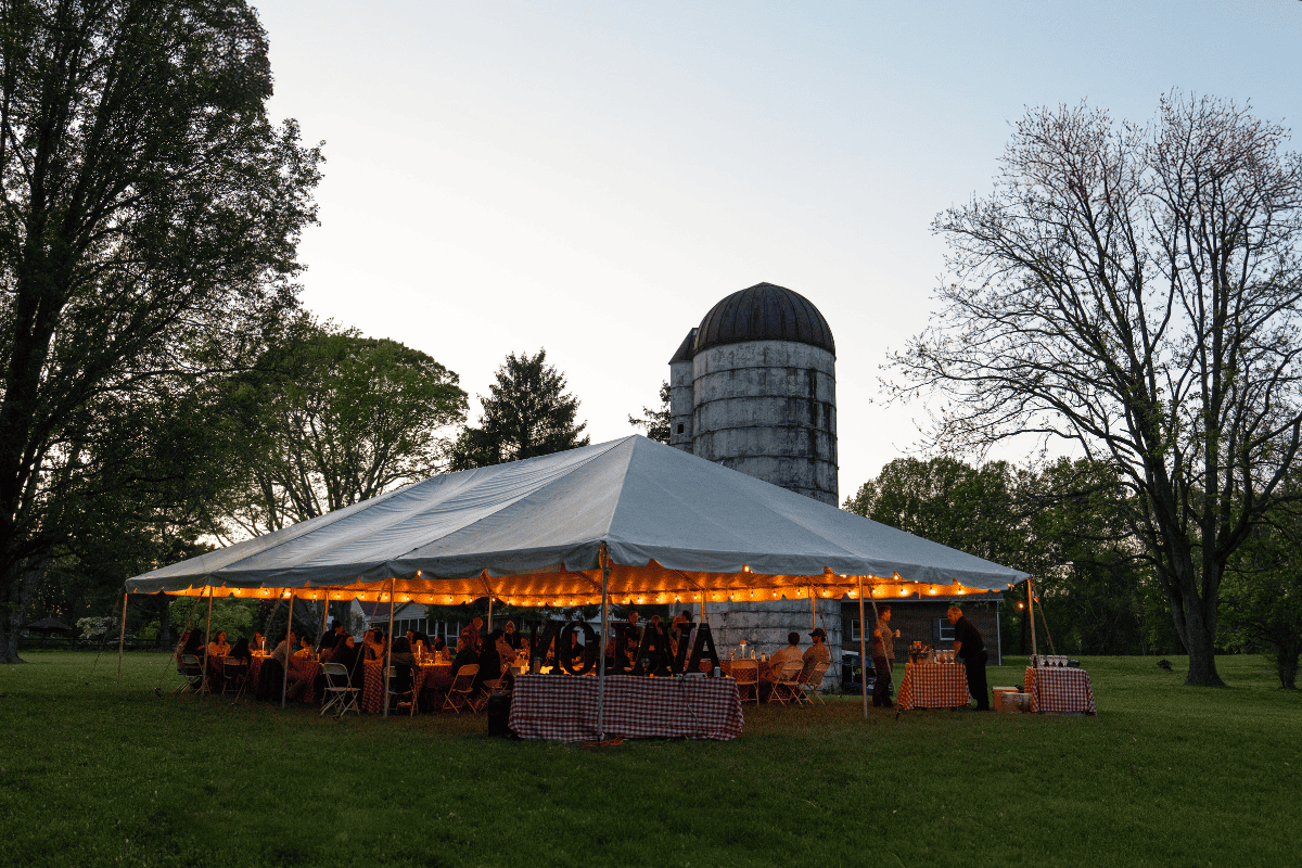 The tent at dusk with the silo in the background.