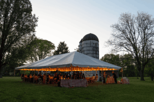 The tent at dusk with the silo in the background.