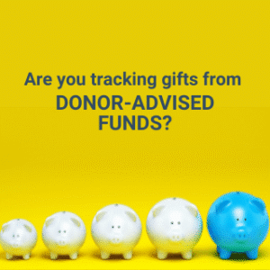 Five piggy banks are lined up in a row against a yellow background, four white and one blue. Text above them reads, Are you tracking gifts from DONOR-ADVISED FUNDS?.