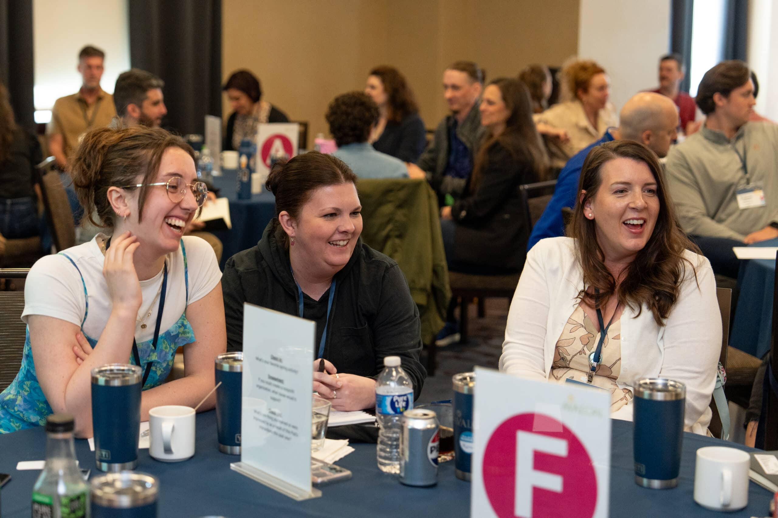 A table of people talking animatedly at a training.