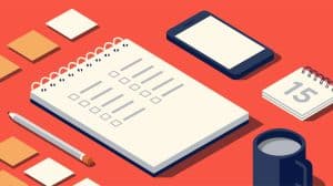 A flat lay of a notebook, phone, and coffee