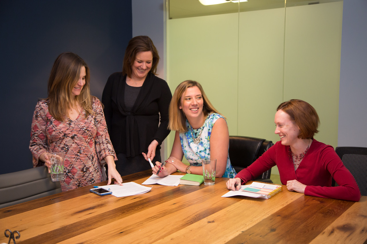 Dara Margot Lucy Anne laughing at conf. table